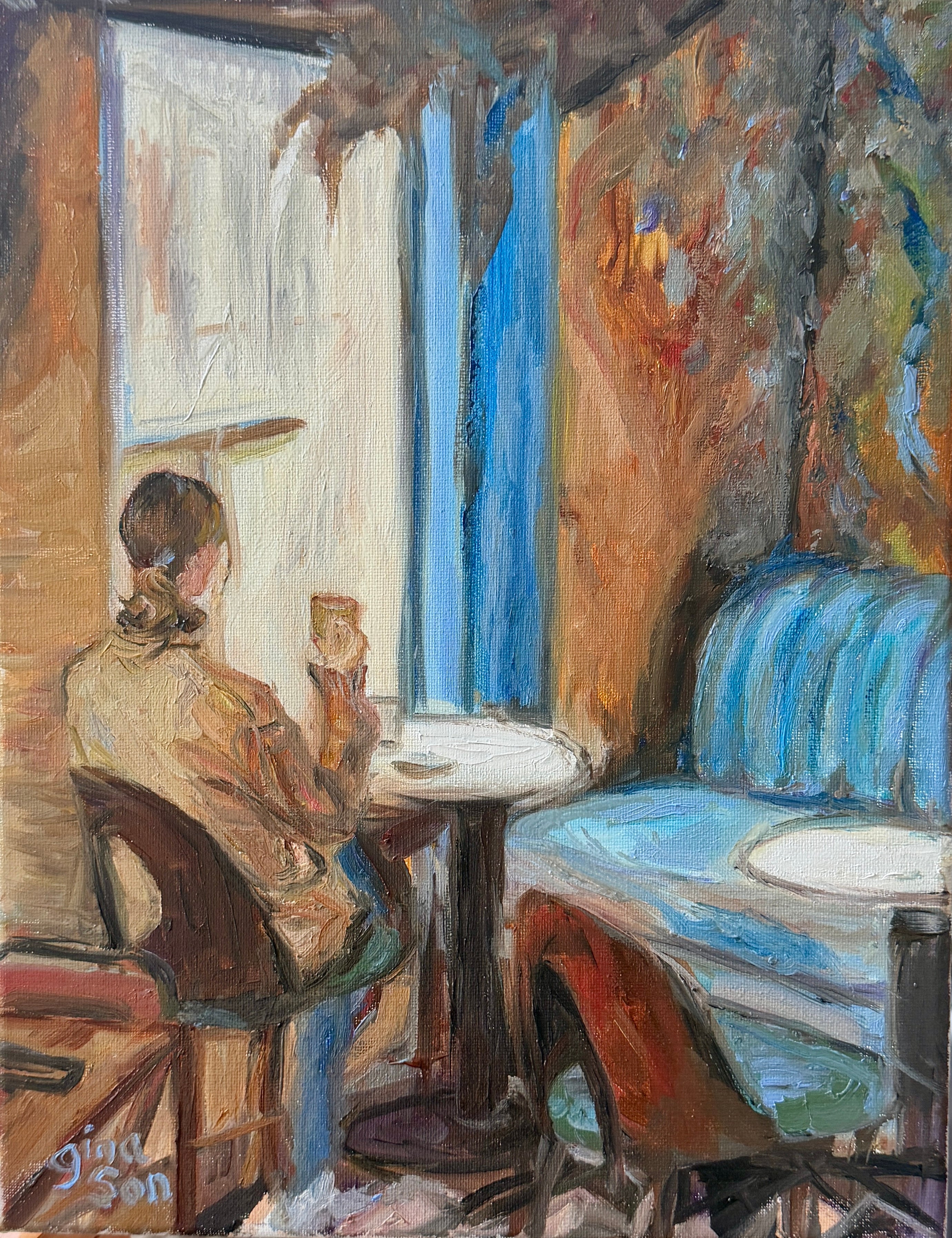 Original oil painting by Gina Son of a solitary woman with a macchiato in a café beside a bright window and blue banquette.